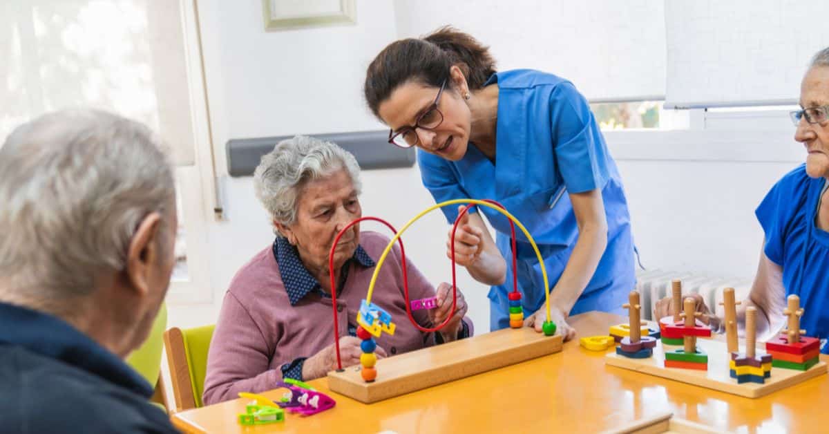 How Daily Routines Support Dementia Care: A Family Guide 1 Nurse Helping Residents In Dementia Care