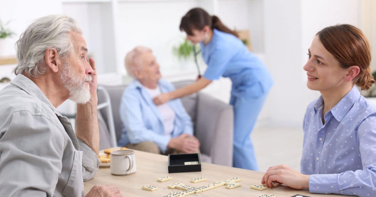 Senior Living Care: Assisted Living Vs Memory Care For Your Loved One 1 Senior Resident Playing With His Daughter In Senior Living Community