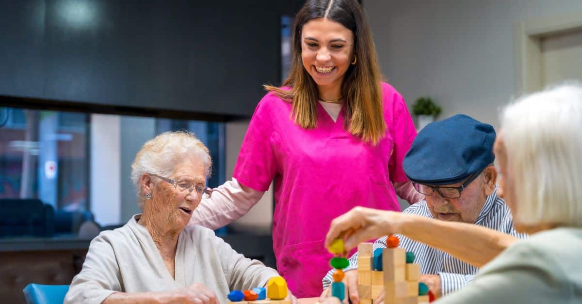 What Does Assisted Living Include? A Guide For Orange City Seniors 1 Happy Nurse Talking With Group Of Senior Residents In Assisted Living Community